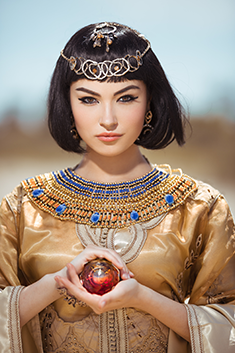 mystical Egyptian girl holding crystal ball